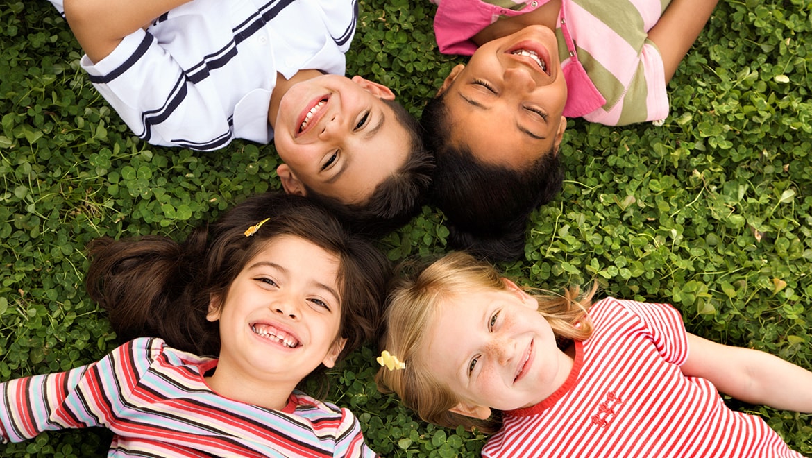 Kids laying in the grass