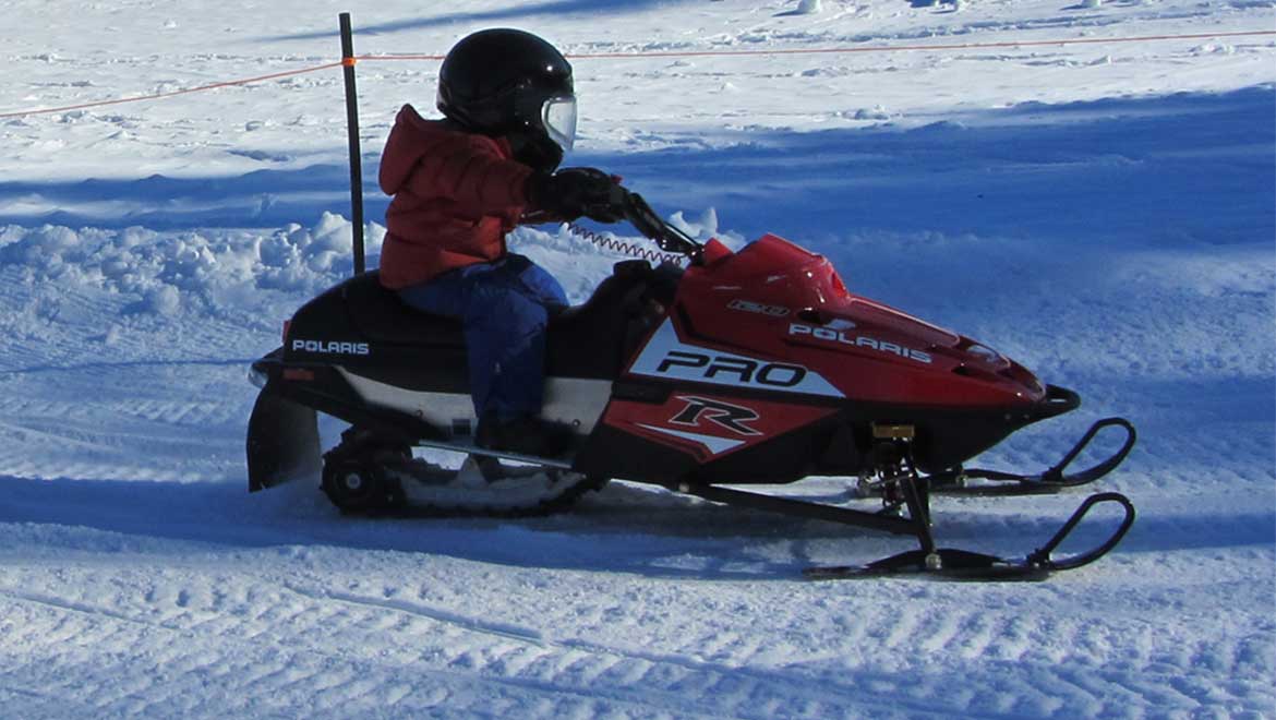Person riding snow mobile