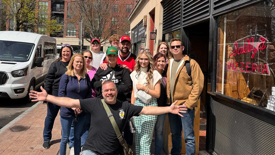 Tourist group posing in front of restaurant