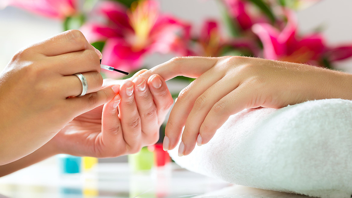 Woman getting nails painted.