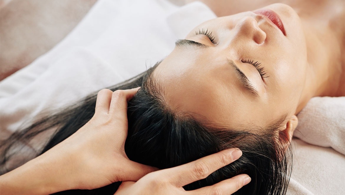 Woman receiving scalp massage.