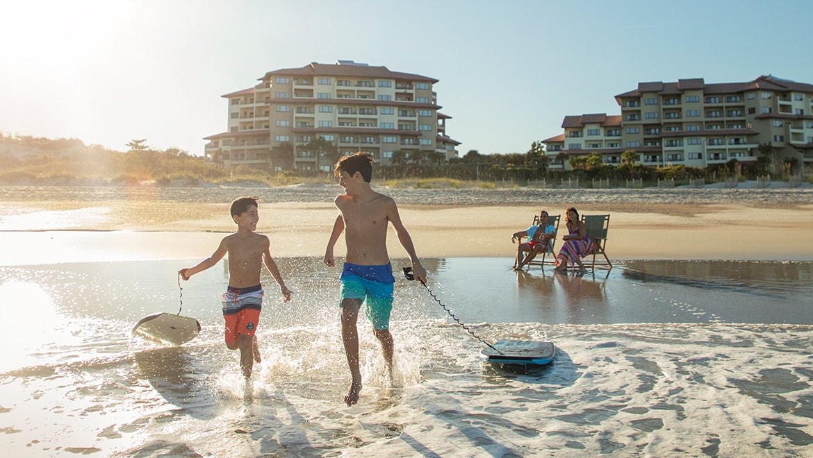 boys on the beach boogie boarding