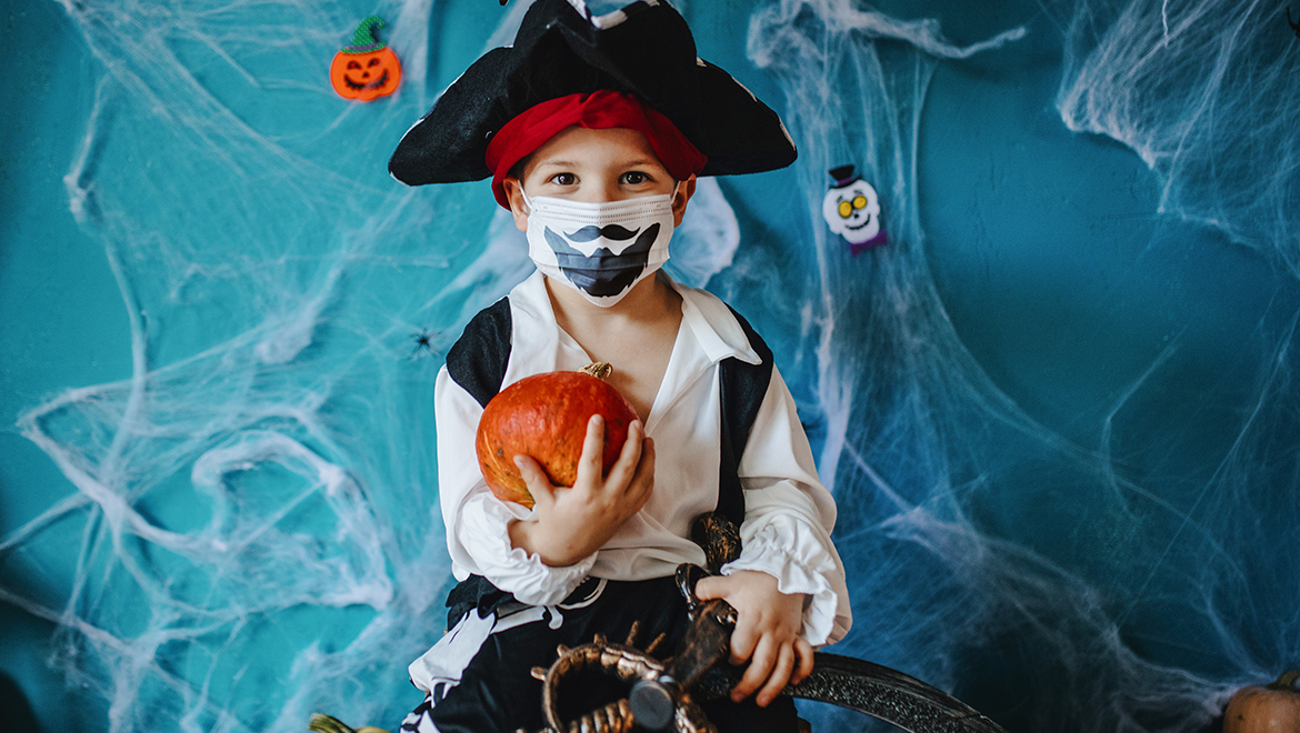 Young Boy in Pirate Costume with Face Mask