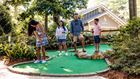 family playing mini golf