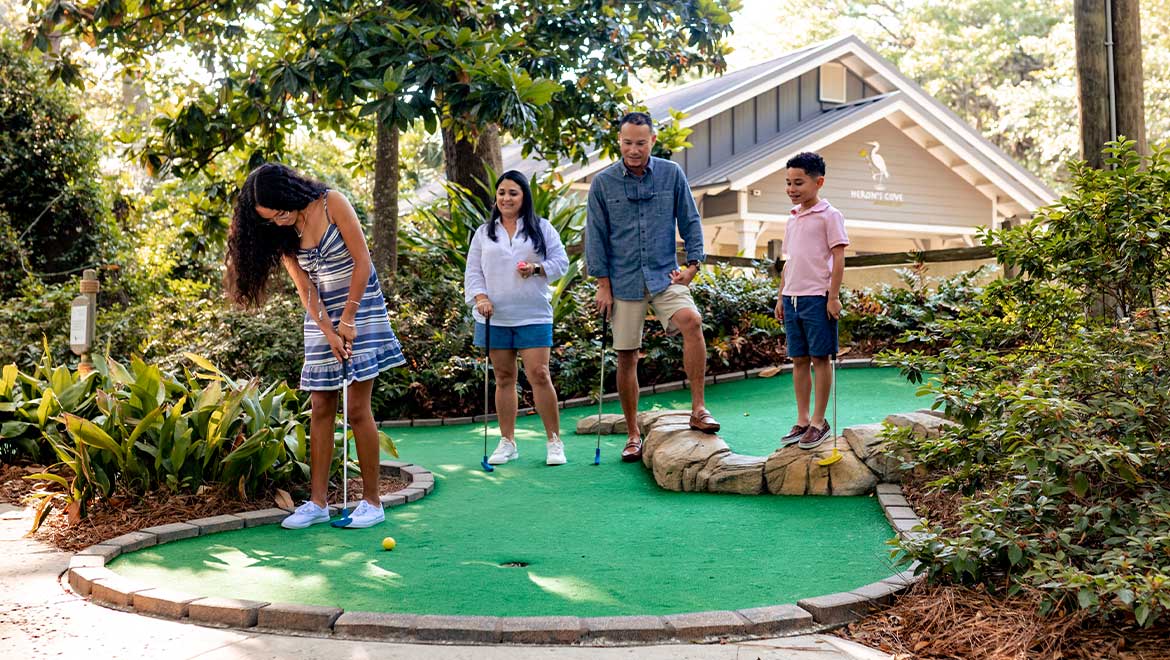 family playing mini golf