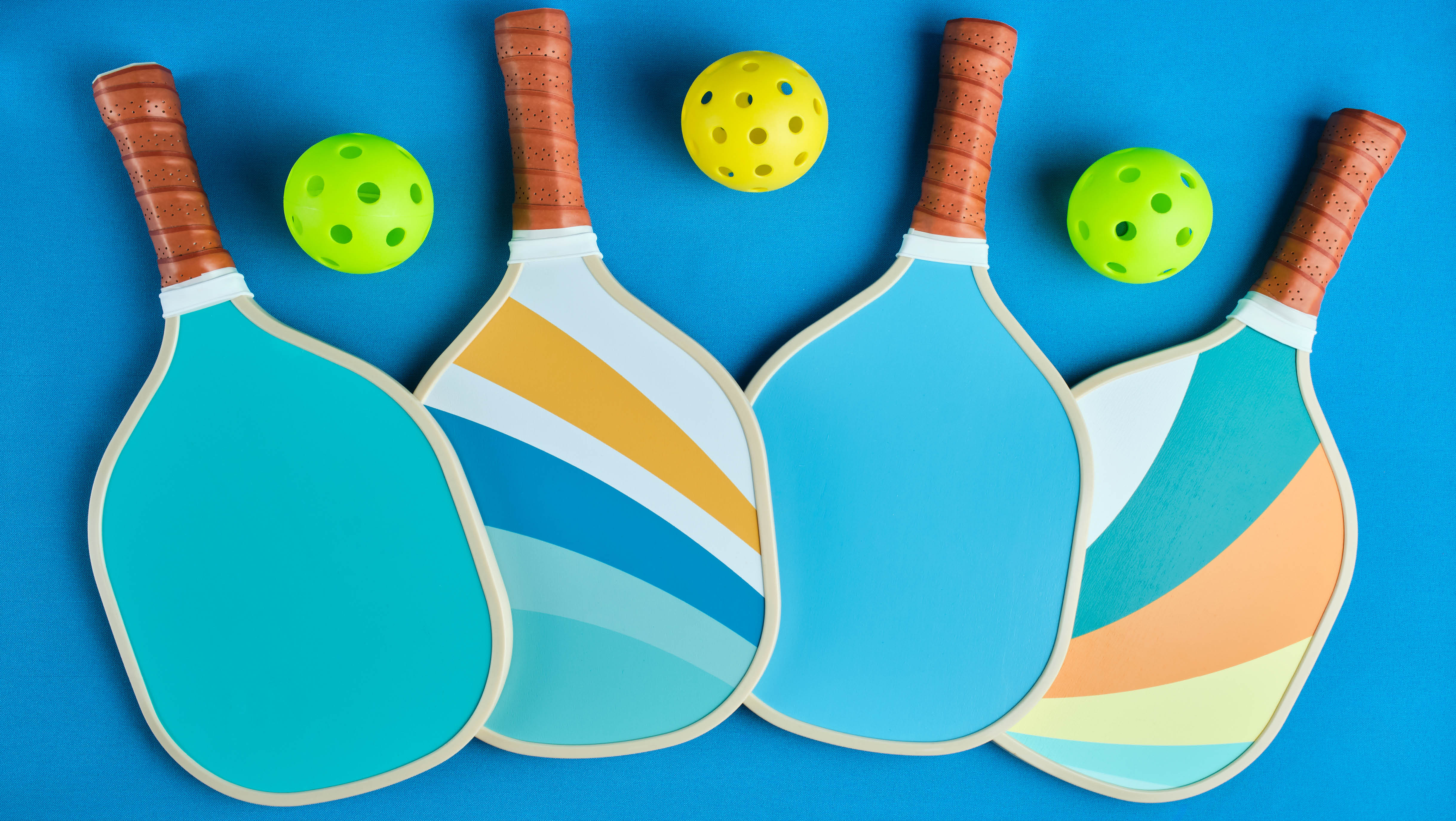 Blue pickleball paddles and balls at  