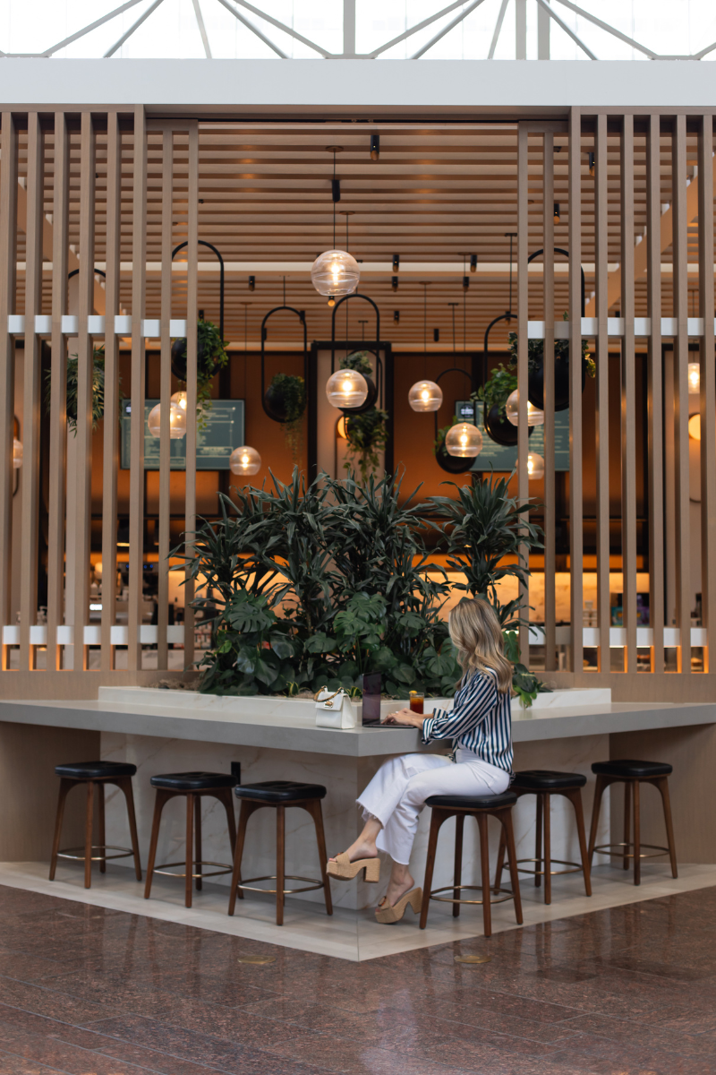 woman working in atrium lobby at Omni Austin Hotel Downtown