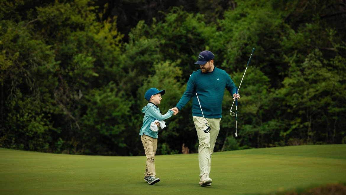 lifestyle father and son golf course