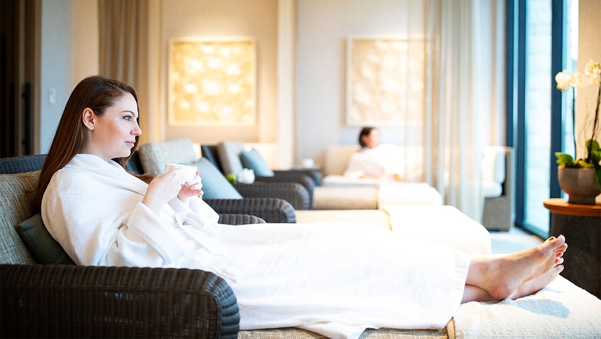 Woman relaxing in a spa robe.