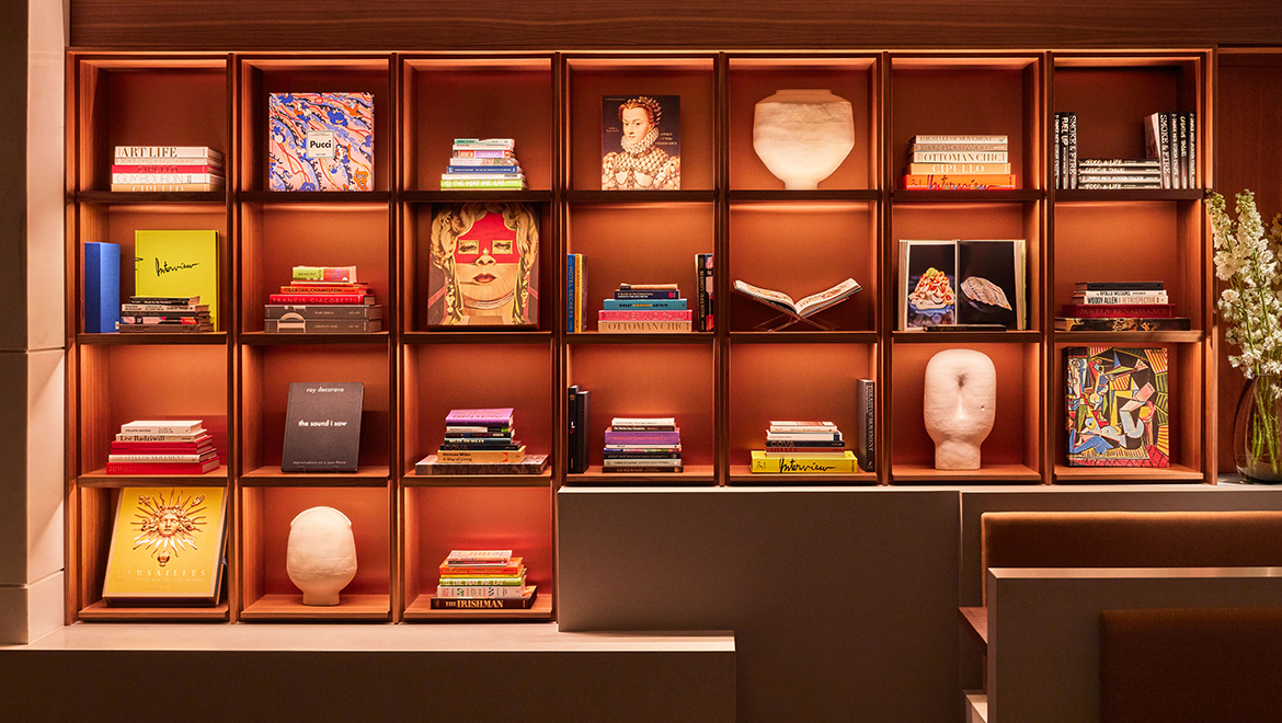 The bookcases in Kestra incorporate the performing arts and academic ties to Boston with literature - Omni Boston Hotel at the Seaport