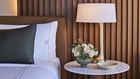 Patron Tower guest rooms feature rich design details like wood slat headboard walls - Omni Boston Hotel at the Seaport