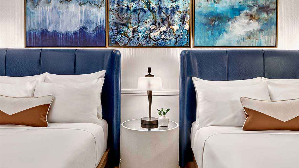 Two queen beds with nightstand in the middle