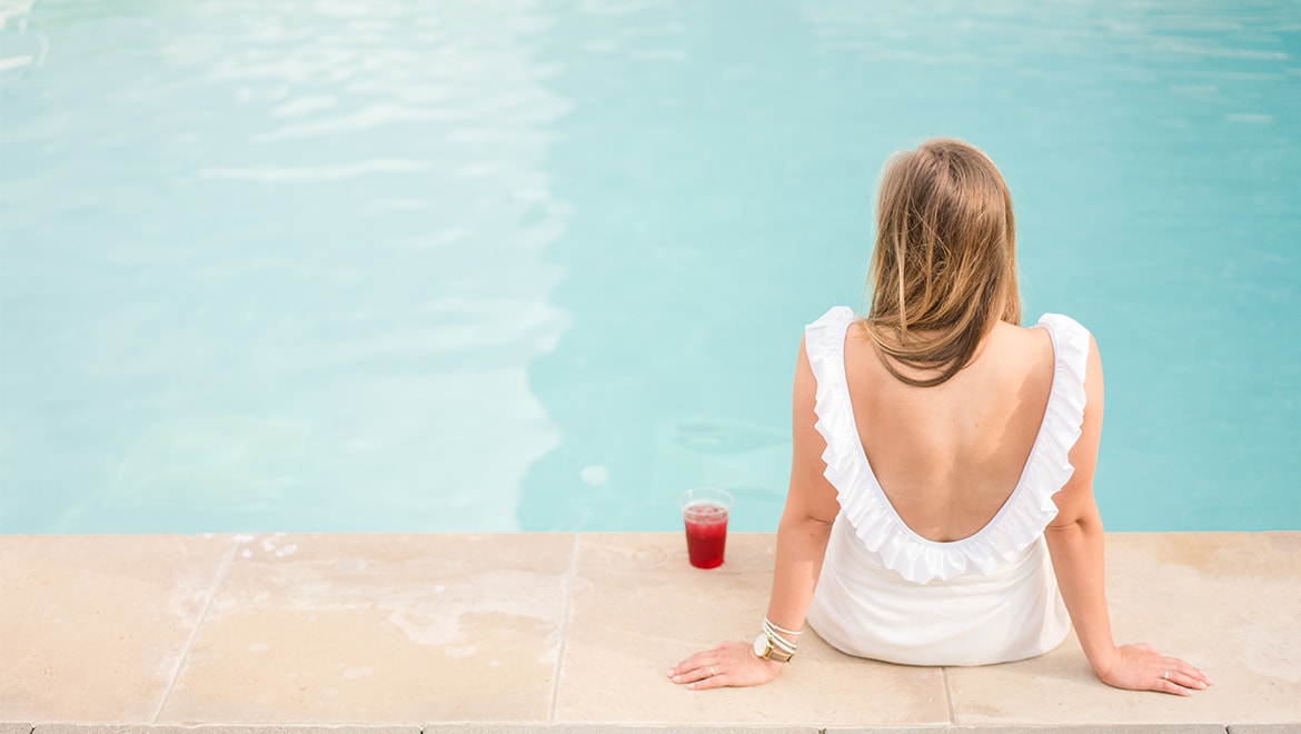 Girl sitting on side of pool