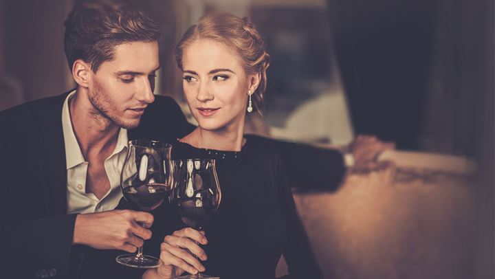 Couple toasting wine. 