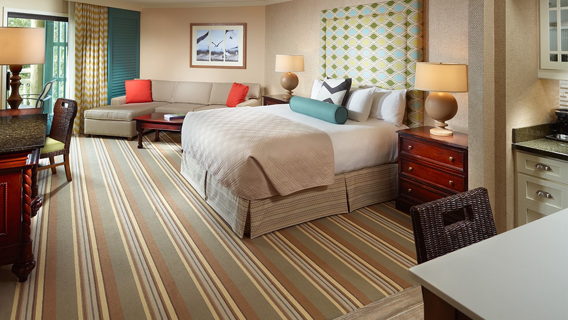 Newly renovated guest room with king bed and sofa