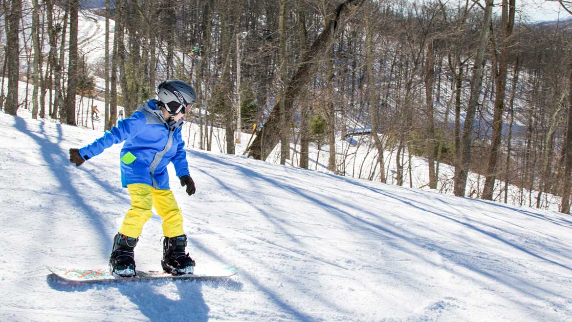 Kid snow boarding.