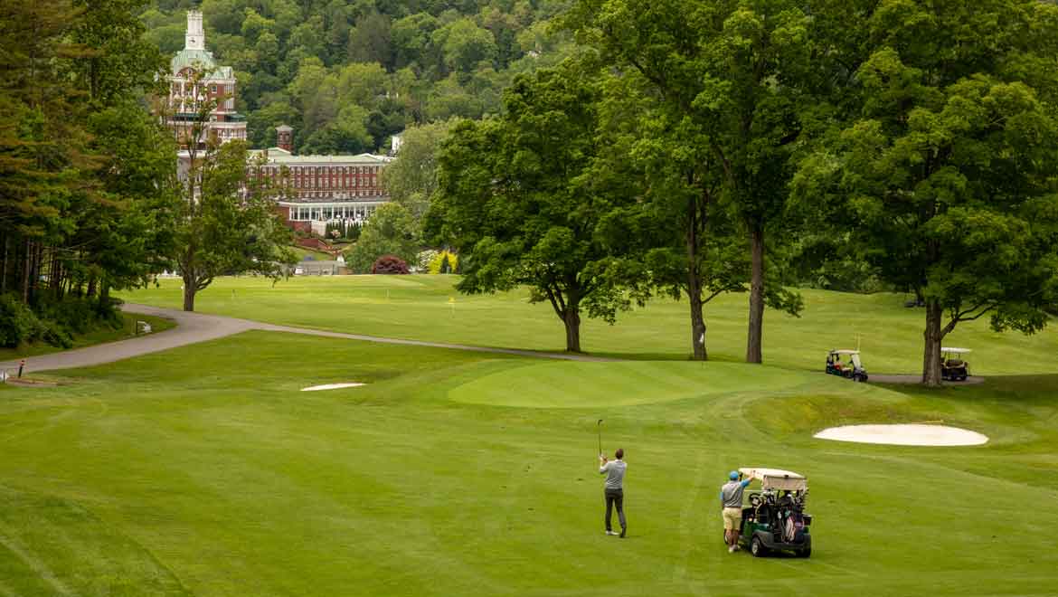 People golfing on the golf course.