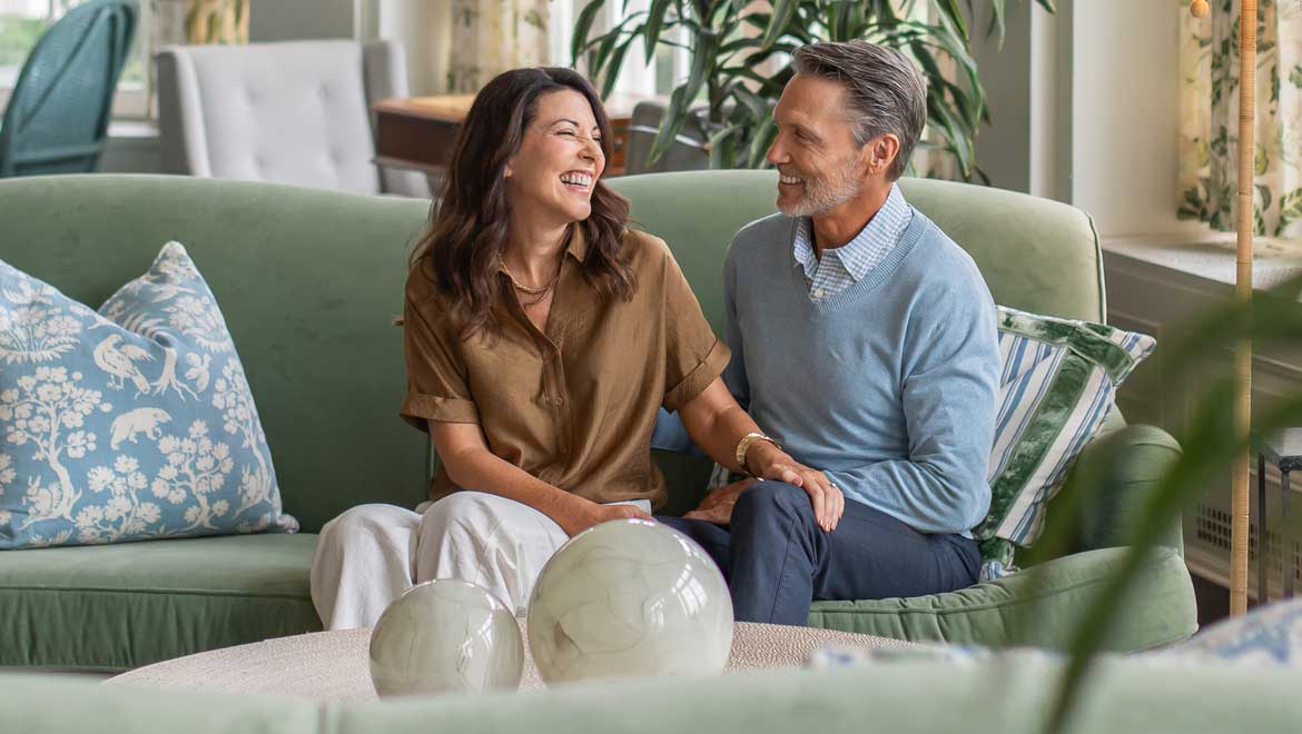 People visiting on the couch in the lobby.