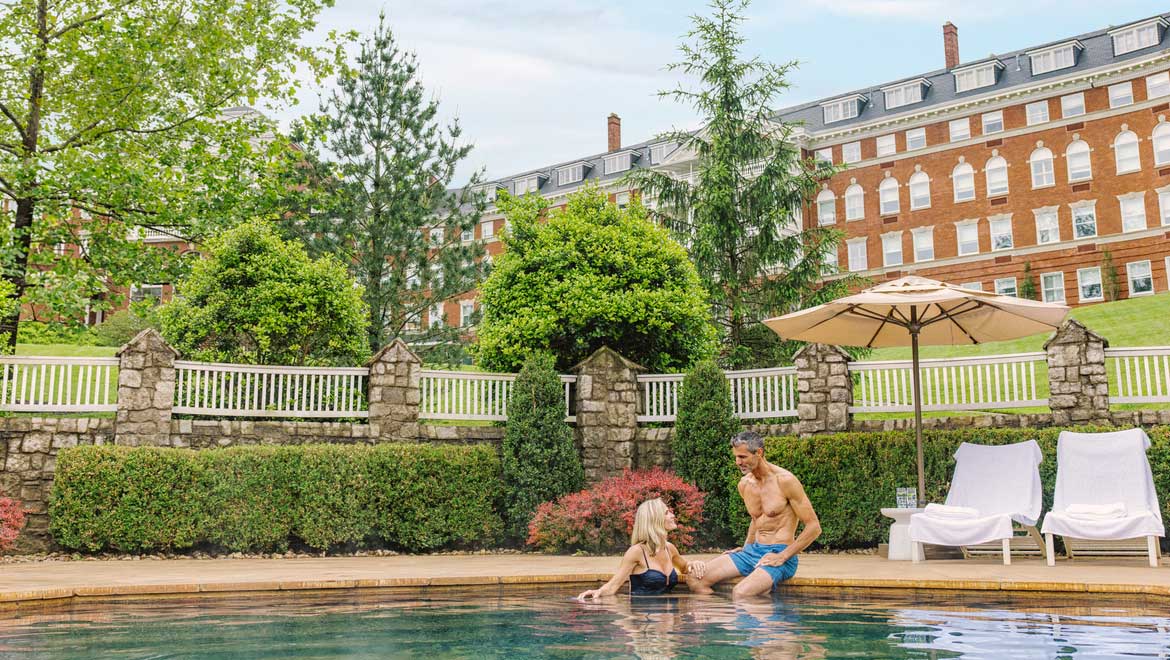 People relaxing in outdoor pool.