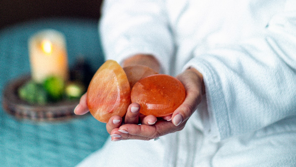 Women holding spa stones