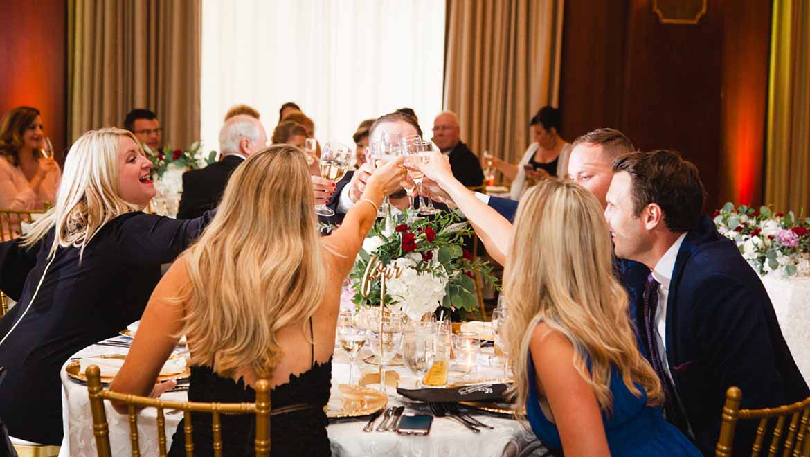 Guests toasting at reception.