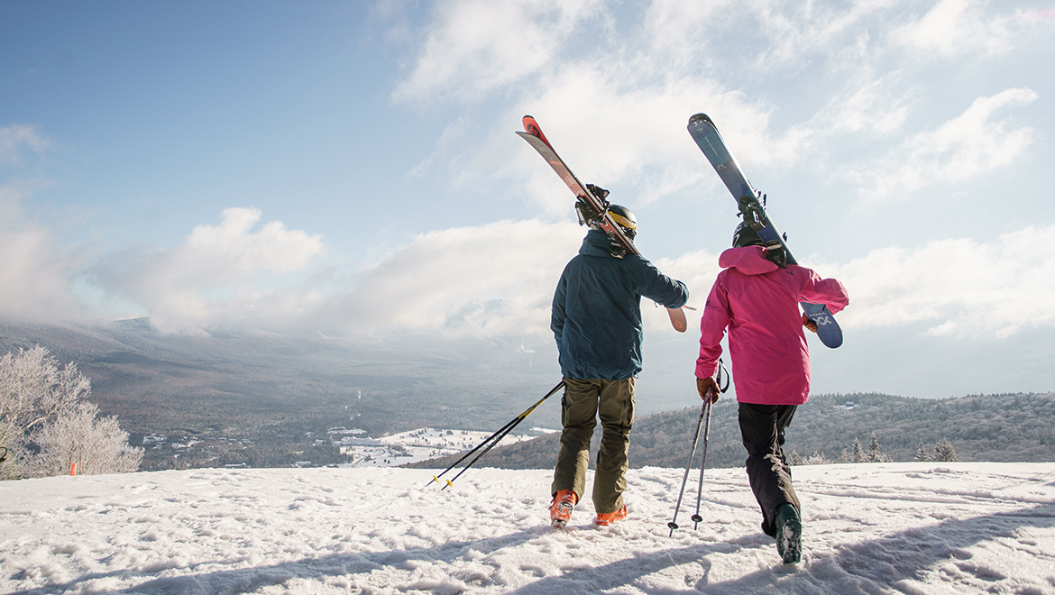 Skiers walking with skis