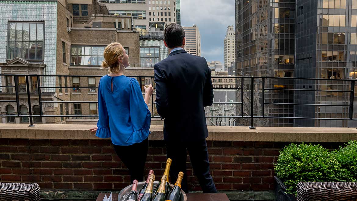Couple enjoying view from terrace.