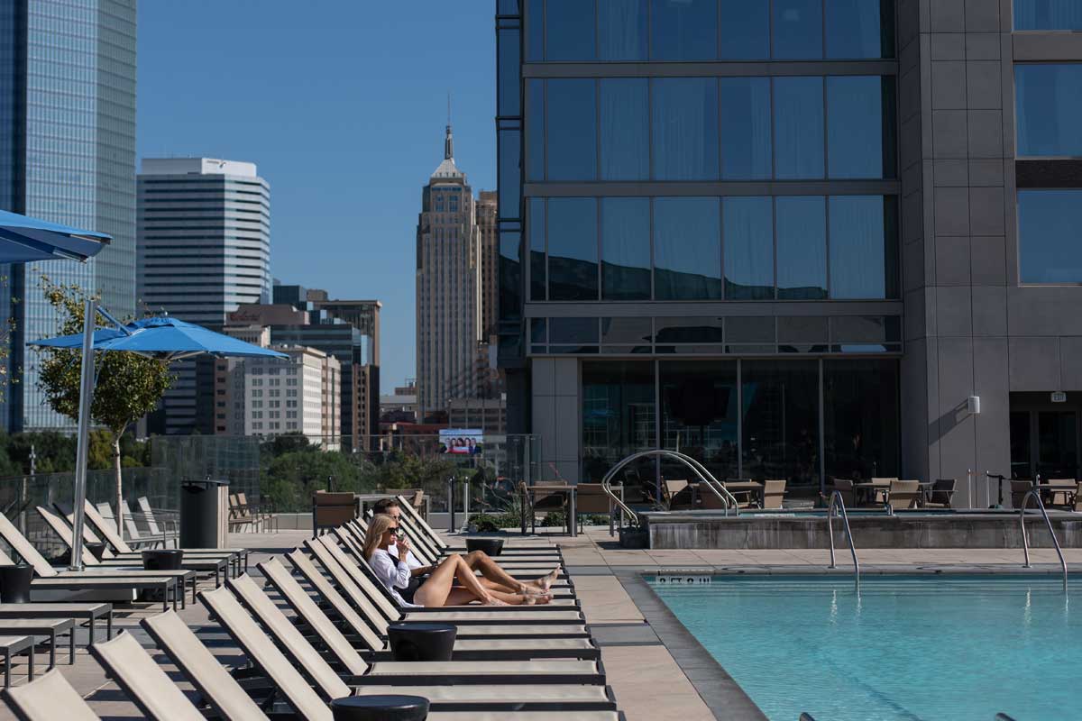 Couple lounging poolside.