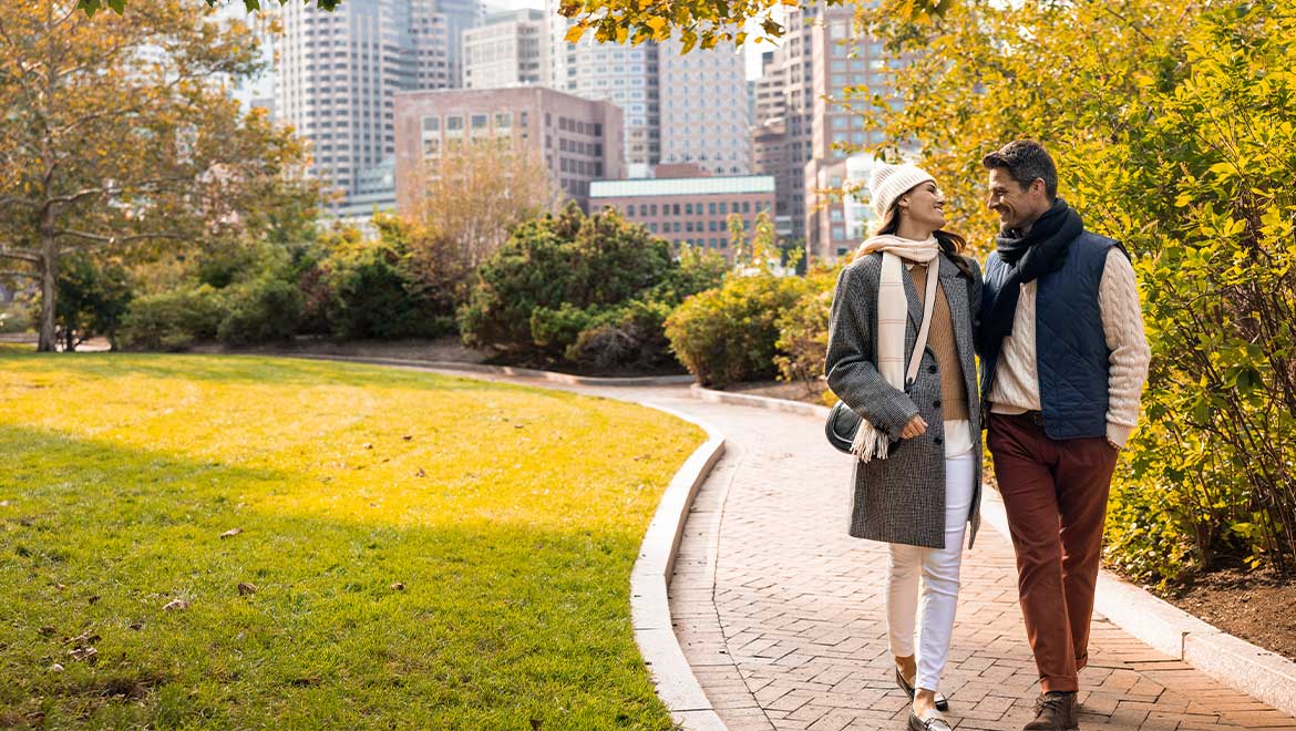 Couple walking through a park
