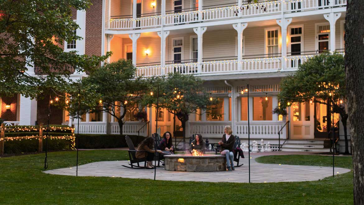 Guests sitting around the fire pit.