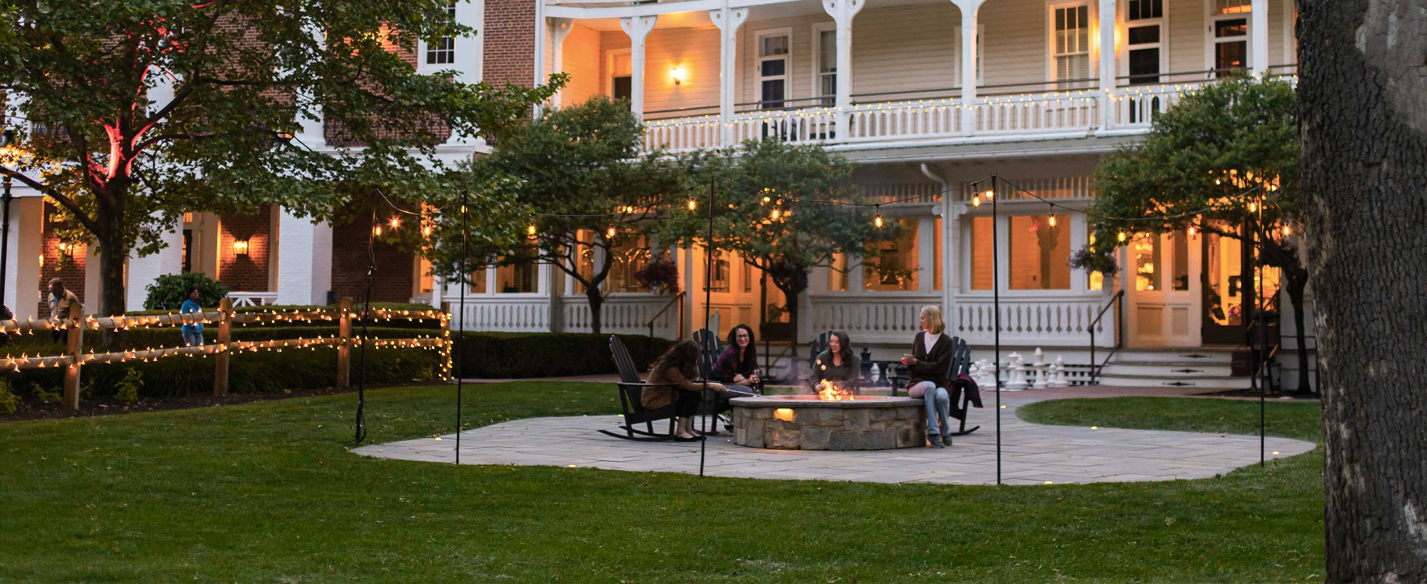Group of women sitting around a firepit