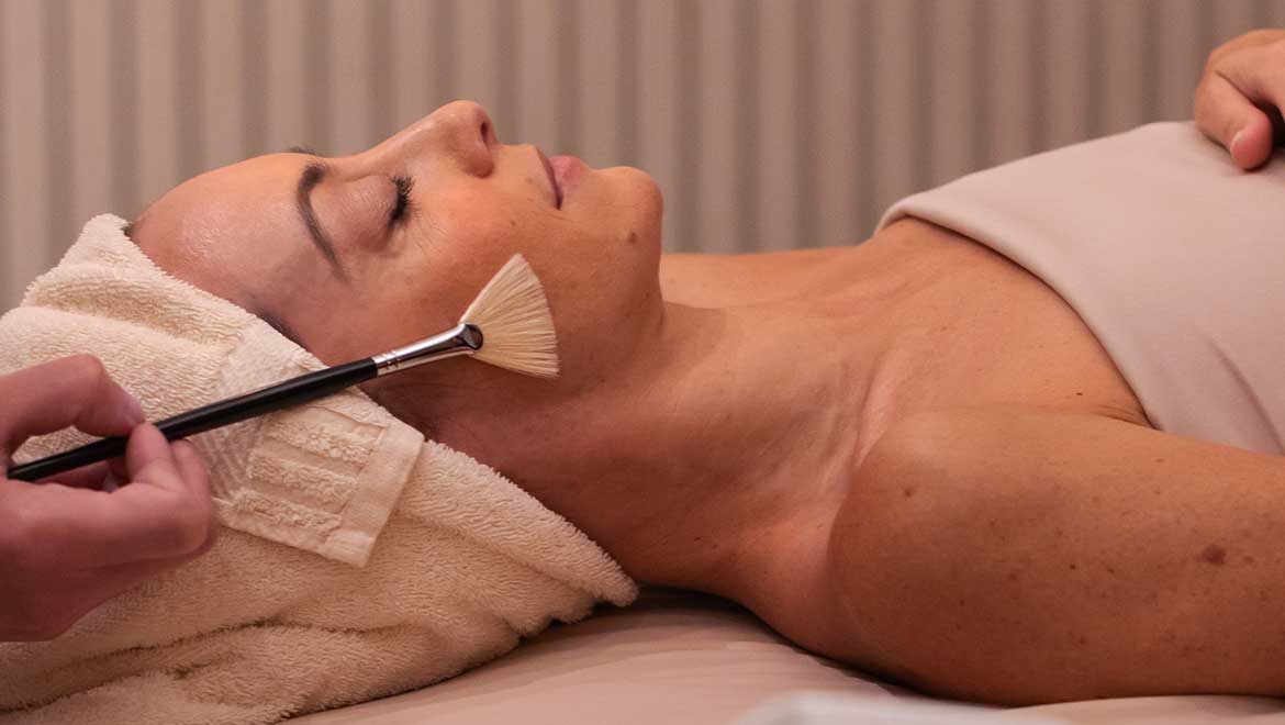 Woman receiving facial treatment