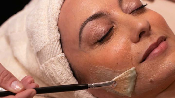 Woman receiving facial treatment.