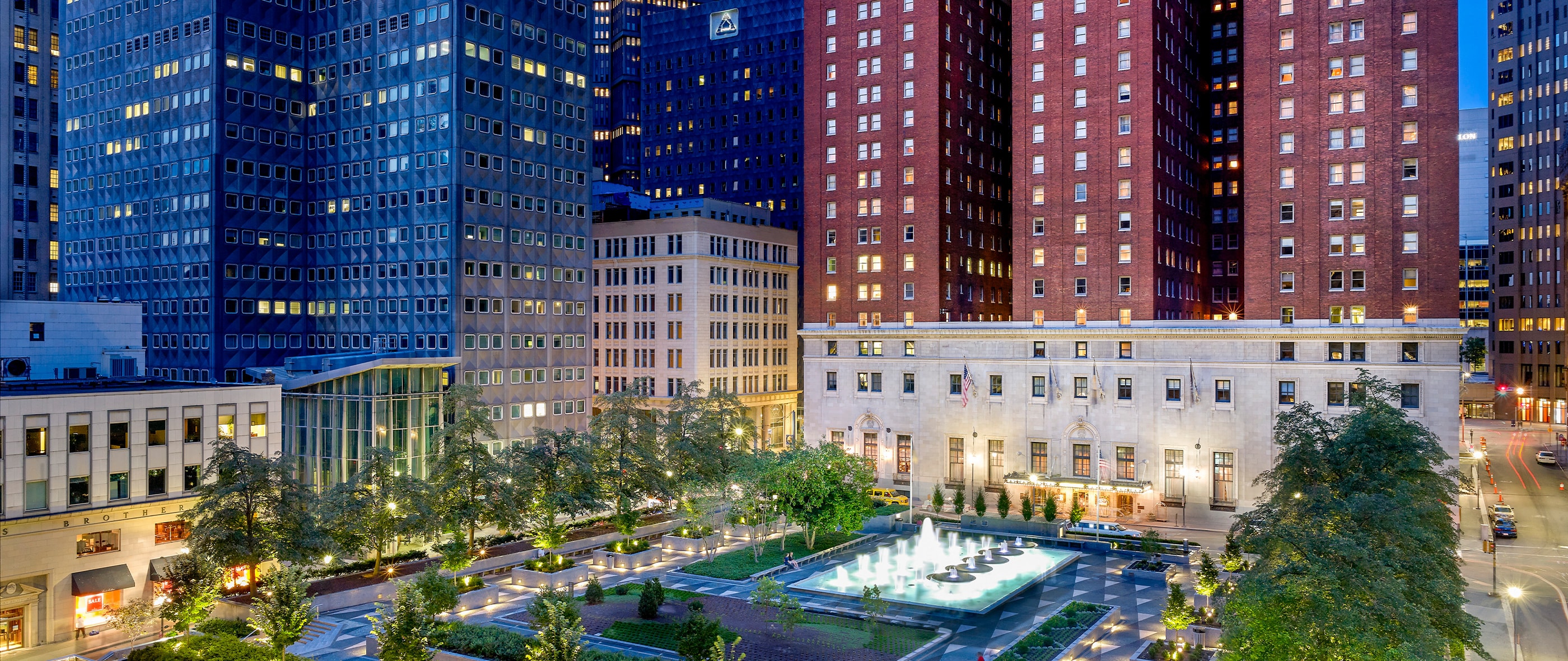 Exterior of hotel and view of fountains.