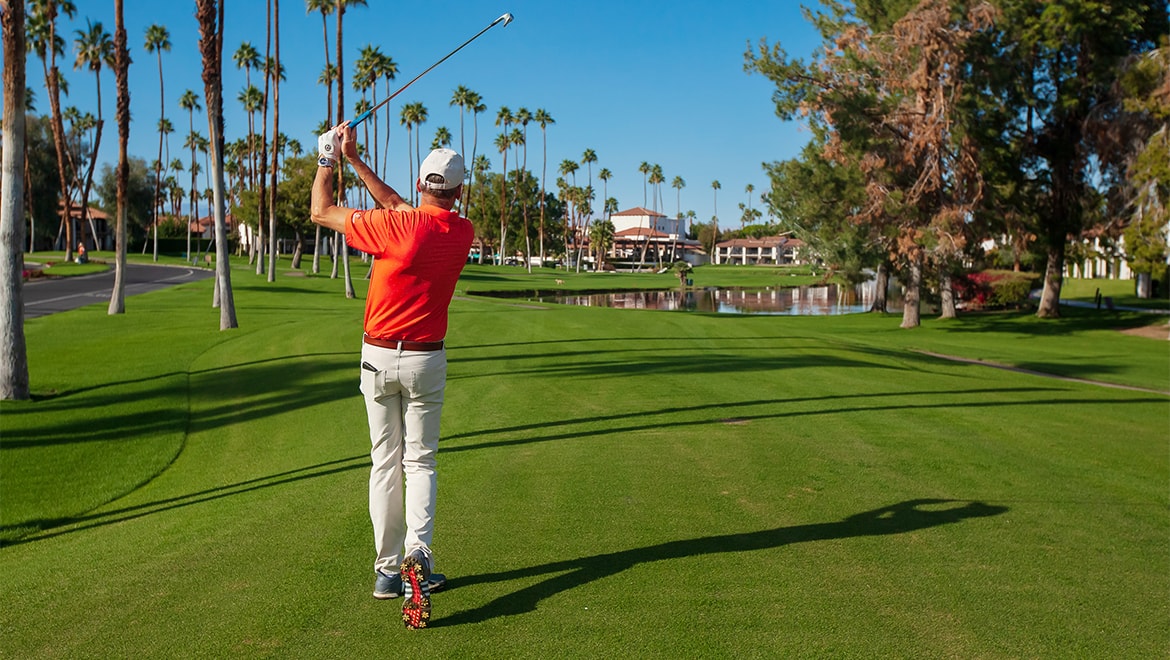 Man hitting ball down fairway.