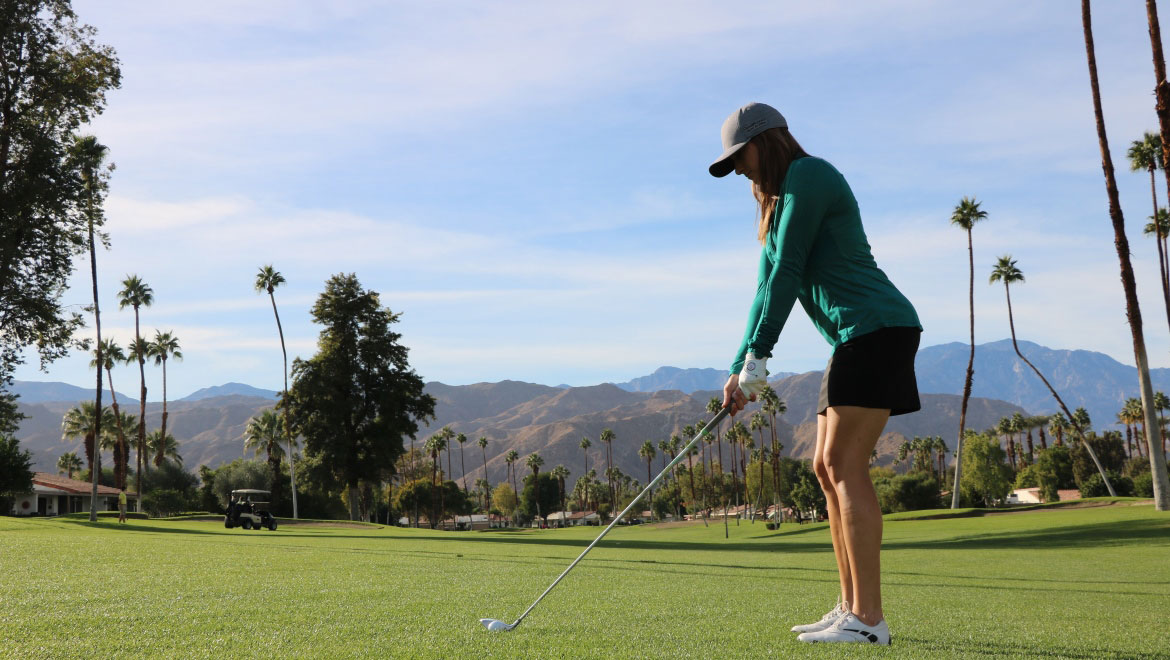 Woman playing golf.