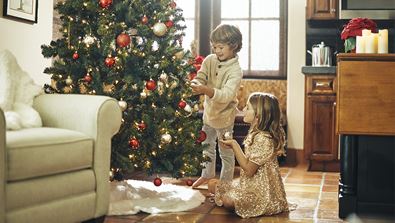 Kids decorating a Christmas tree
