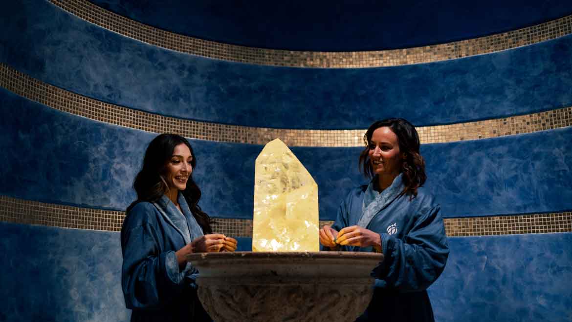 Spa women looking at the crystal.