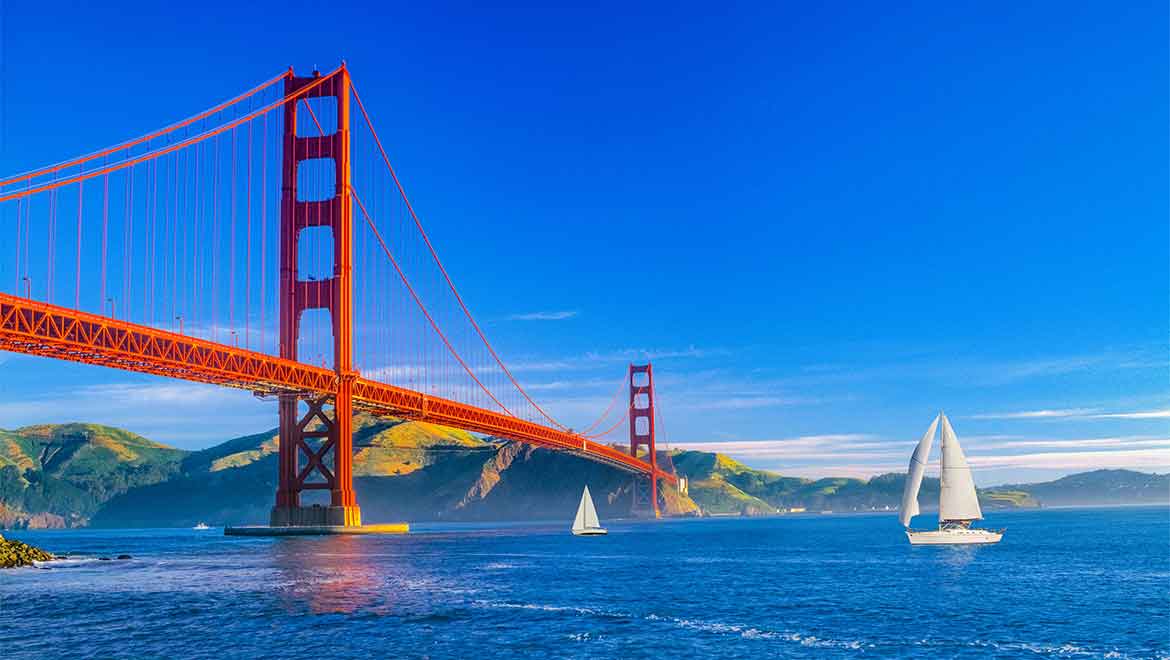 Sailboats on the ocean near Golden Gate Bridge.