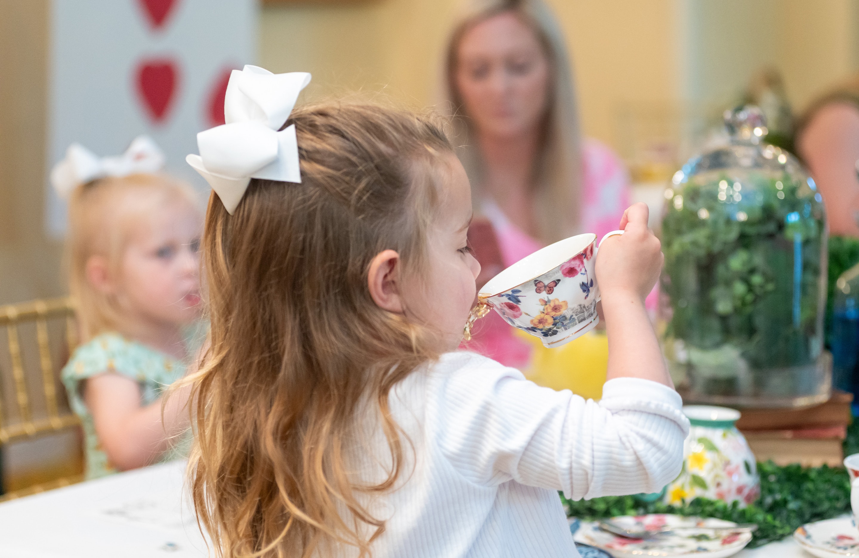 little girl sipping tea