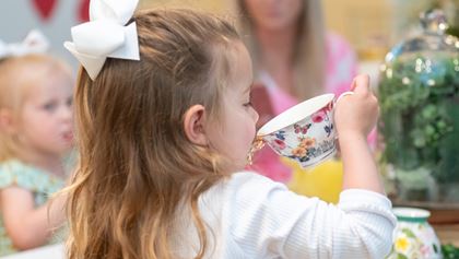 Little girl drinking tea.