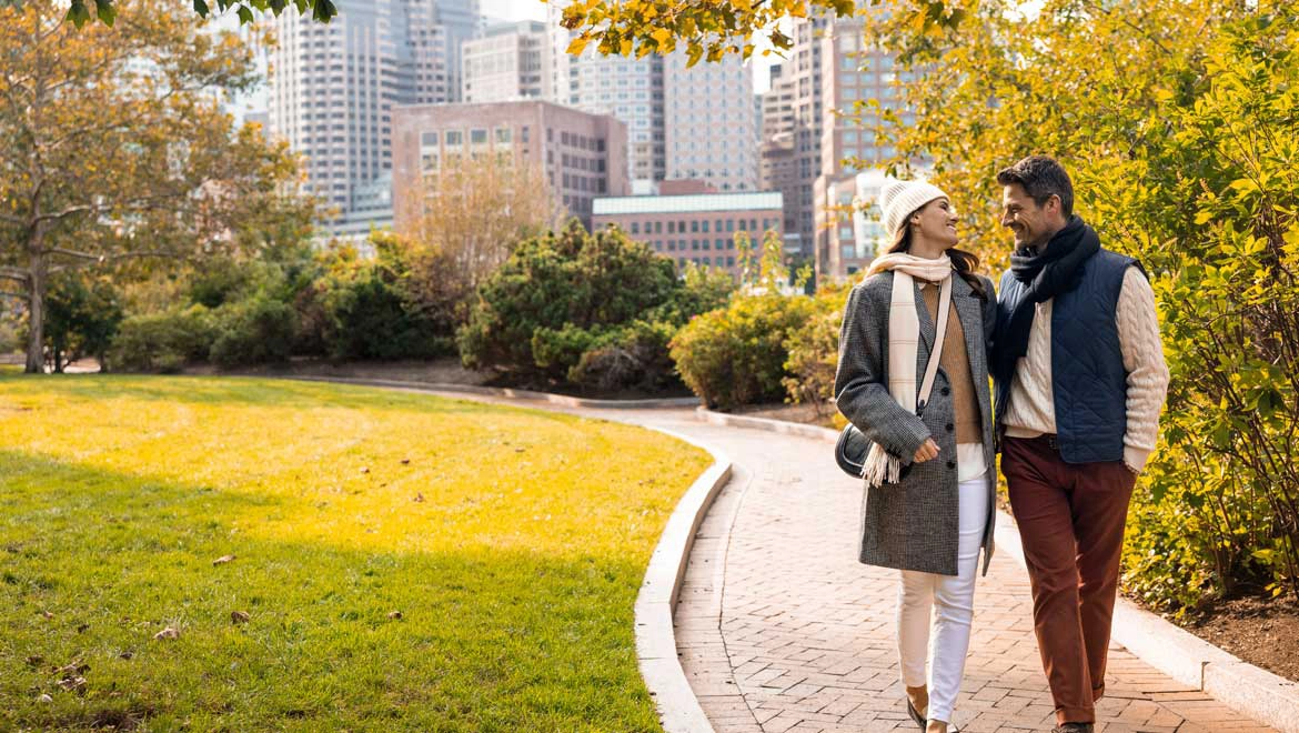 Couple walking in the fall leaves.