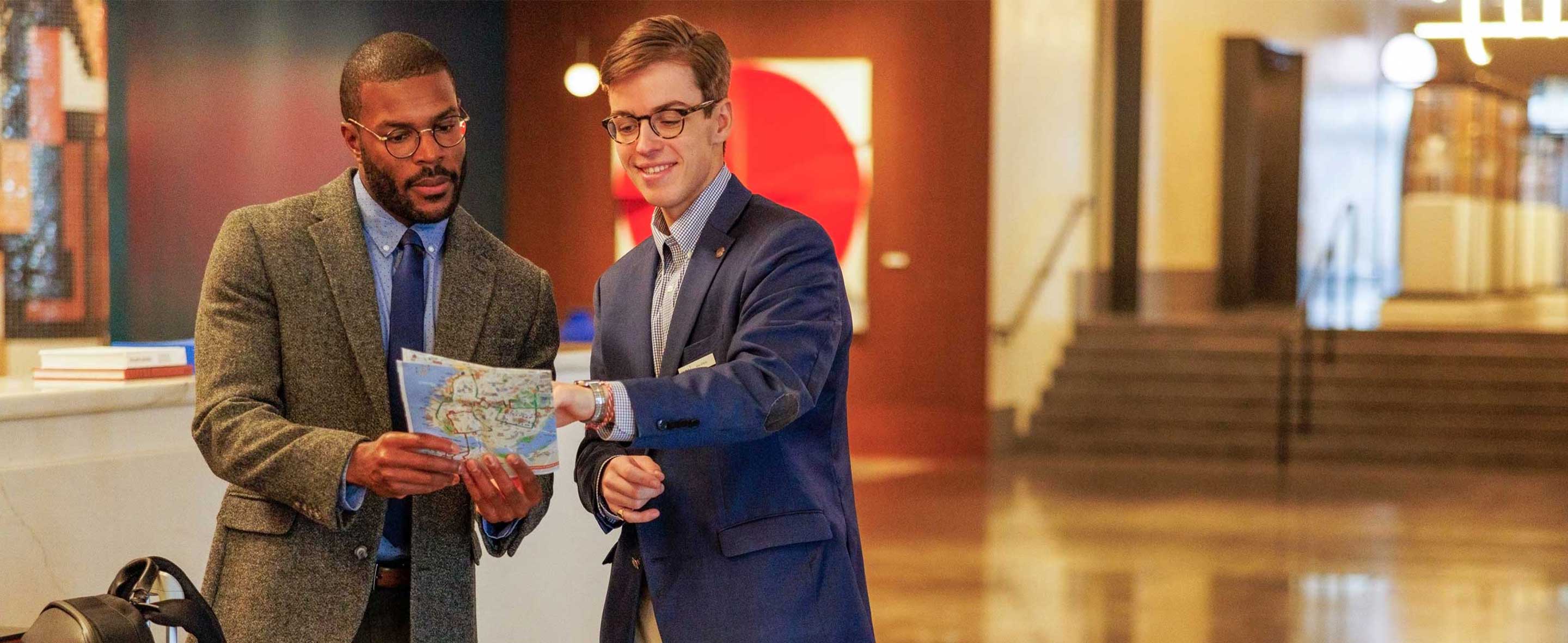 Man helping guest with directions